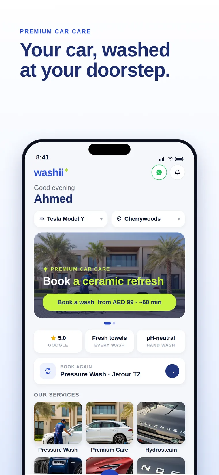 Washii app home screen with a saved Tesla Model Y in Cherrywoods, a book a wash card from AED 99, and the Pressure Wash, Premium Care and Hydrosteam services.
